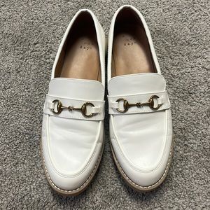 White loafers with gold detail